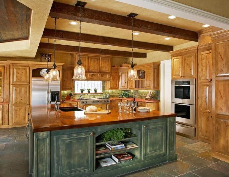 Built-in spotlights and chandelier in the interior design of the country style kitchen